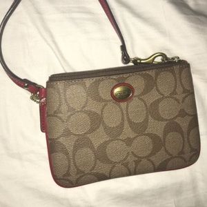 Authentic Coach wristlet with red interior